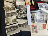 a lot of old postcards and postcards sitting on a table