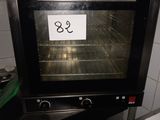 a black oven with a sign on it sitting on a counter