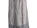 an image of a woman in a long gray dress with ruffles on her shoulders