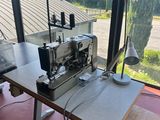 an image of a sewing machine sitting on top of a wooden table