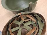 a helmet sitting on a table next to a bowl