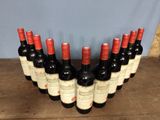 several bottles of wine are lined up on a wooden table