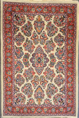 an antique persian rug with a floral design on a beige ground