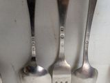 three spoons that are sitting on a table