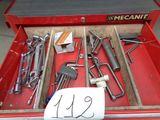 a red tool box filled with tools and a sign