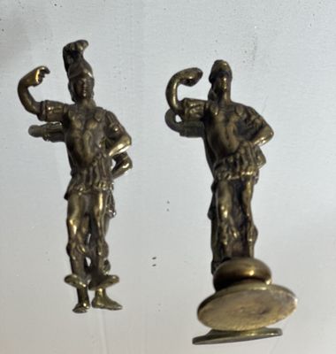 pair of antique brass figurines of a man and a woman