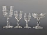 four clear wine glasses sitting on top of a table