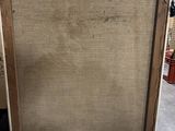 an old picture frame sitting on top of a table in a room