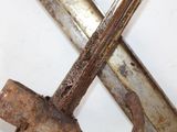 a pair of old rusty tools on a white surface