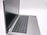 a silver laptop computer sitting on top of a white table