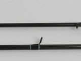 two black and white pens sitting on top of a white surface