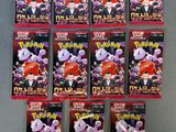 six paquets de cartes à collectionner Pokémon posés sur une surface grise