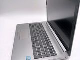 a laptop that is open on a white surface
