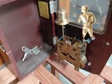 a small wooden box with a clock inside of it