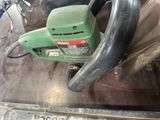 a green machine that is sitting on top of a table