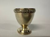 a silver cup that is sitting on a table