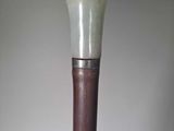 a white and brown cane that is on a table