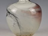 a glass vase with a black and white design on it