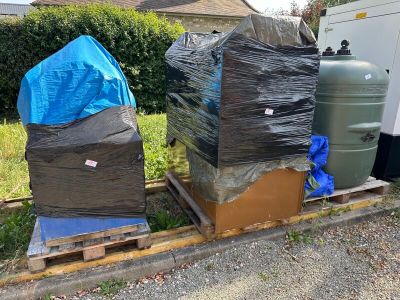 a pile of boxes sitting on top of a pallet in the yard