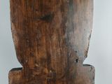 a wooden chair that has a wooden seat on top of it