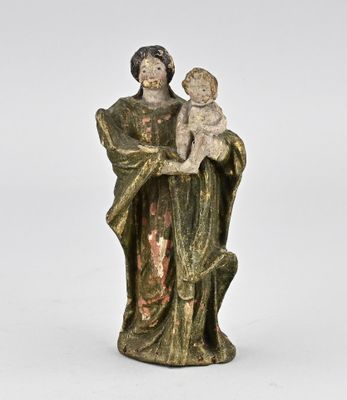 an old statue of a woman holding a baby in her arms