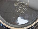 a close up of a black and gold clock on a table