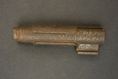 a small metal object on a table with a black background