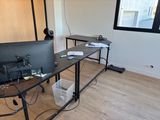 a desk with a computer and a monitor on it