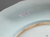a white plate with a brown rim on a table