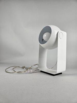 a white lamp that is on top of a table