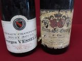two bottles of wine sitting next to each other on a table