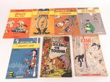 several children ' s comic books are lined up on a white surface