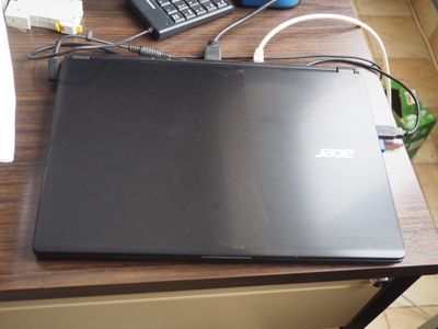 un ordinateur portable posé sur un bureau, avec un clavier et une souris