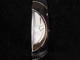 a close up of a watch on a black surface