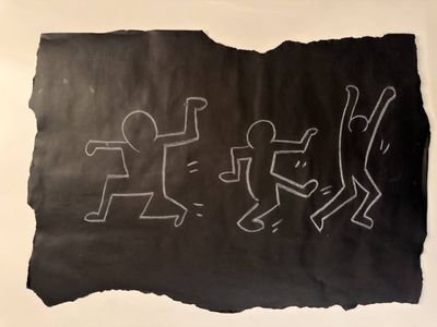 drawing of a group of stick figures on a piece of black paper