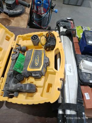 a yellow tool box with tools in it on a table
