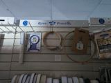 a wall with a bunch of plates and a clock on it