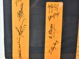 a lot of autographs on a black and orange bag