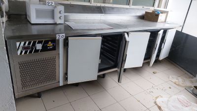 an image of a commercial kitchen with stainless steel counter tops and appliances
