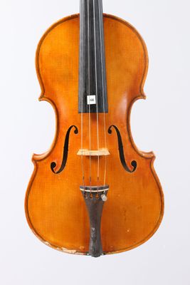 an old violin sitting on top of a white surface