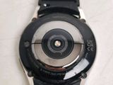 a close up of a watch on a white surface