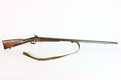 a rifle with a wooden barrel and a sling on a white background
