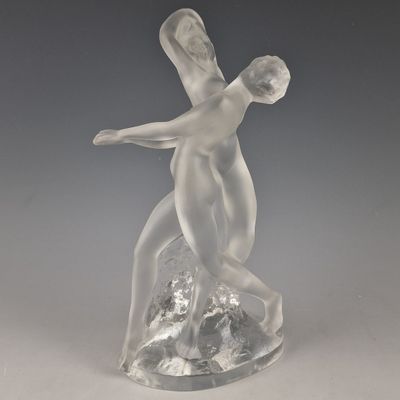 statue of a woman holding a man on a rock on a gray background