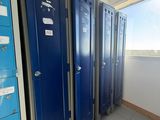 several blue lockers are lined up in a row in a room