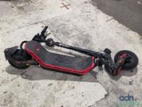 a scooter that is laying on the ground on the street