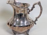 an image of a silver pitcher on a white surface