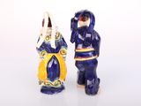 two salt and pepper shakers on a white surface