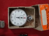 a box with a watch inside of it on a red surface