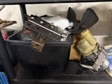 an image of a black trash can filled with assorted items