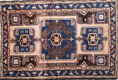 an old rug with a blue and brown design on it